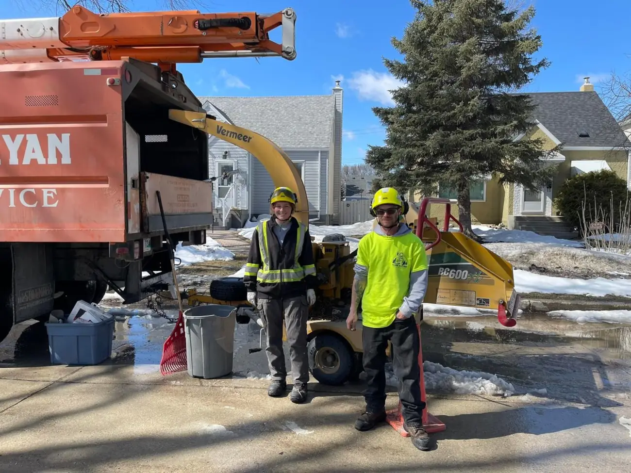 Pierre Bunyan crew by chipper PIerre Bunyan arborists standing near the chipper